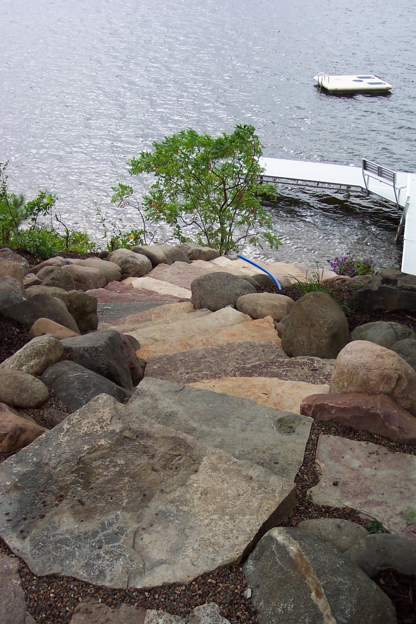 Boulder and flagstone path leading to lake dock