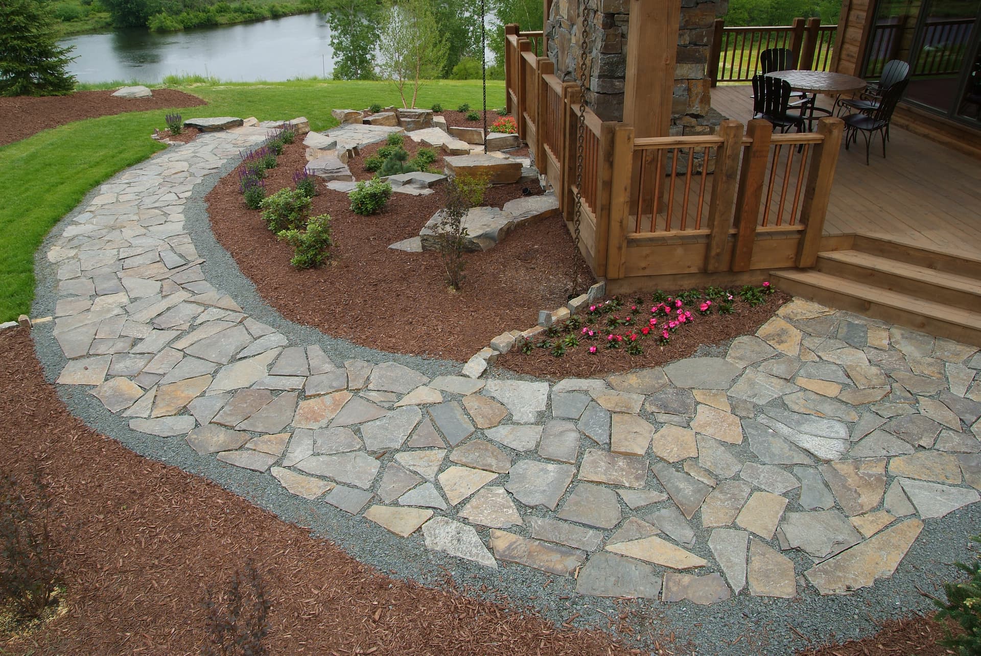 Curved flagstone walkway with gravel border on lakefront property
