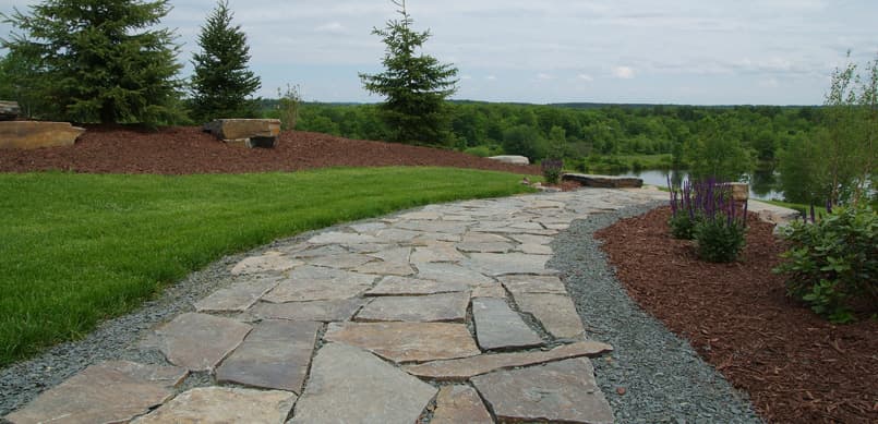 Flagstone walkway with gravel border through landscape