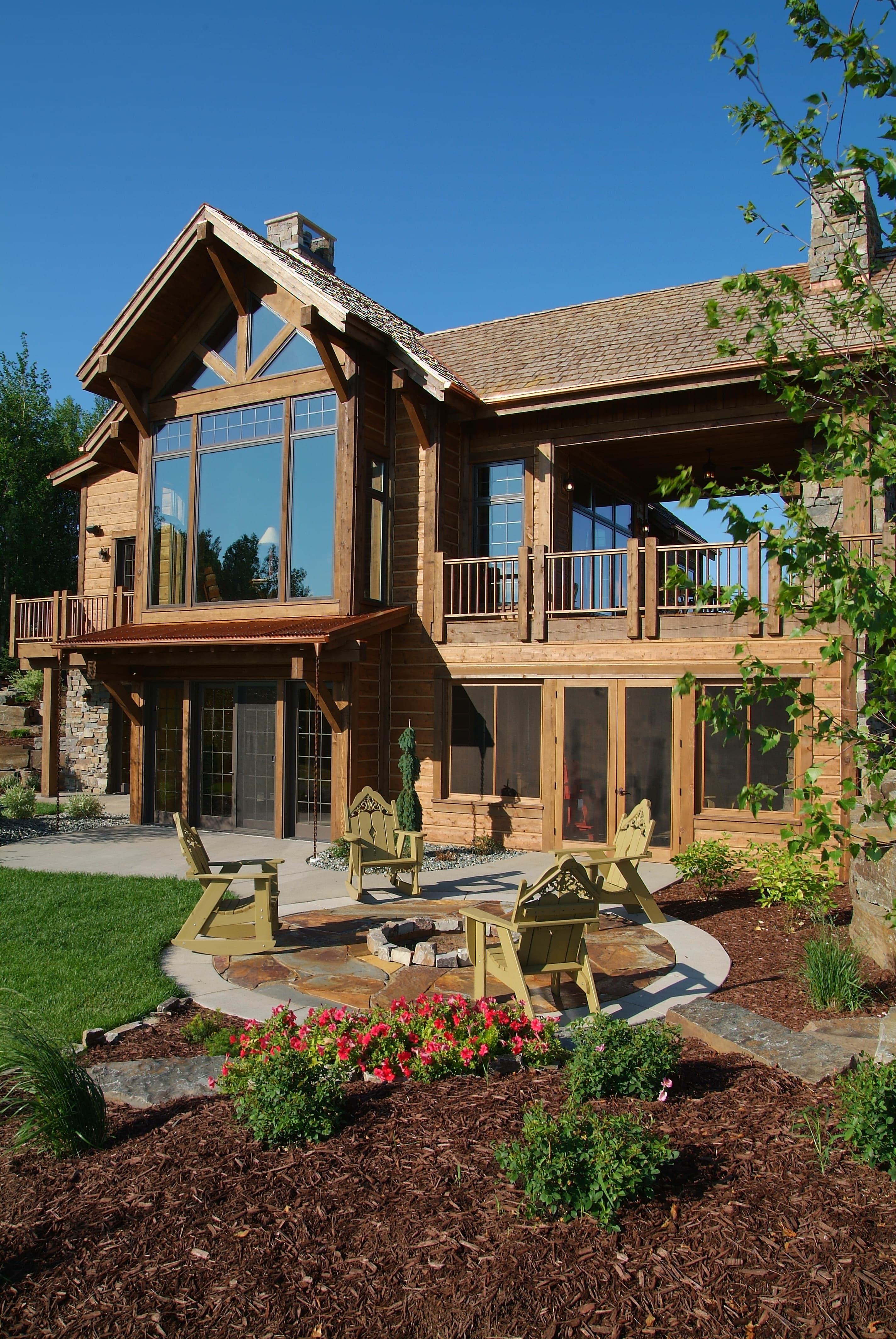Log home patio with fire pit and landscaping